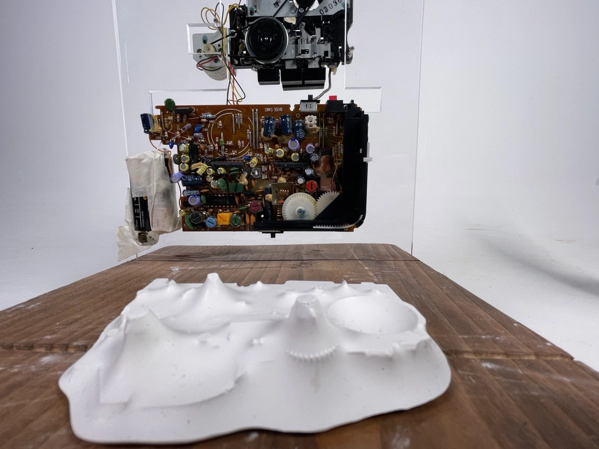 Concept model: Walkman parts above a plaster ground